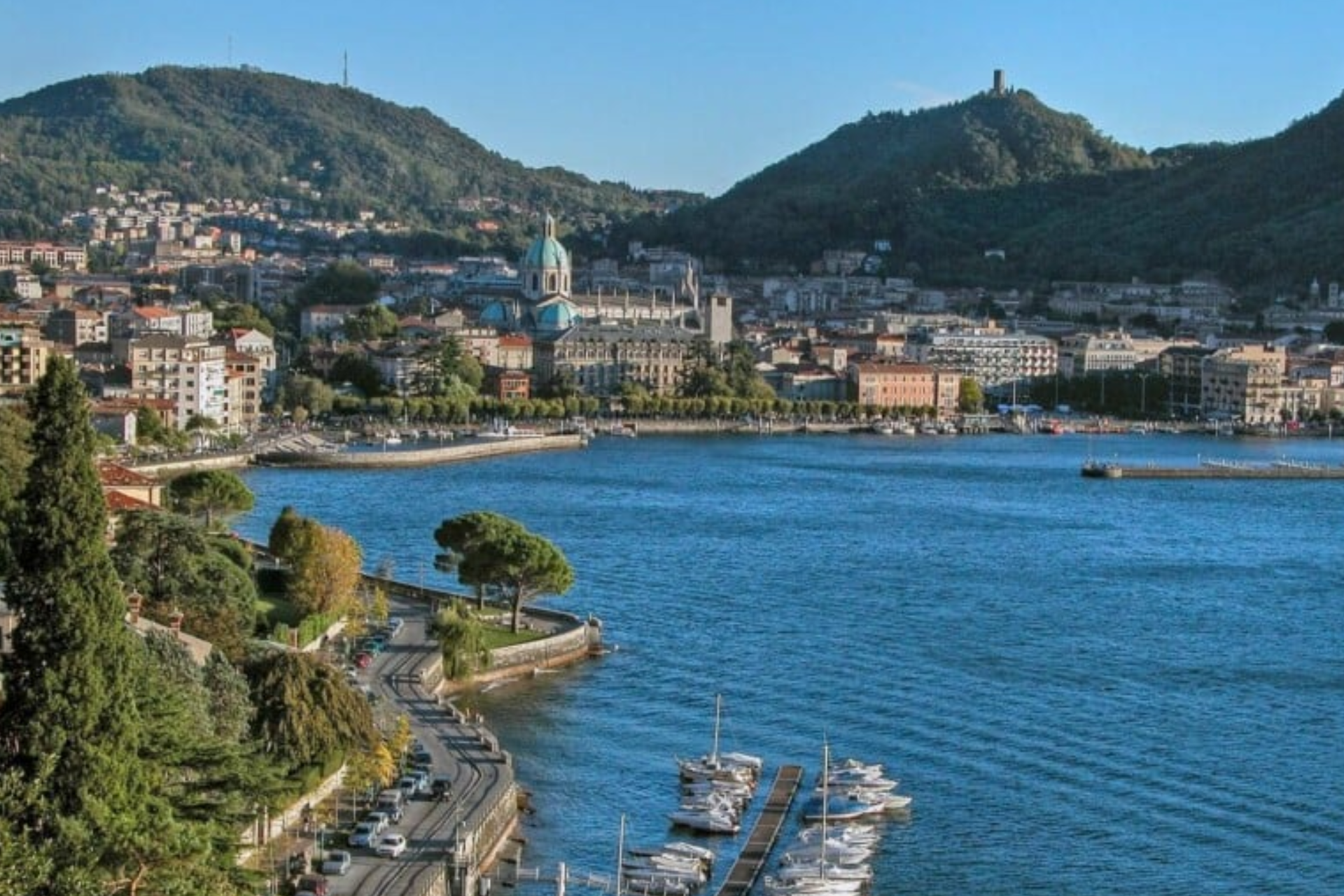 An aerial view of a city surrounded by water and mountains.