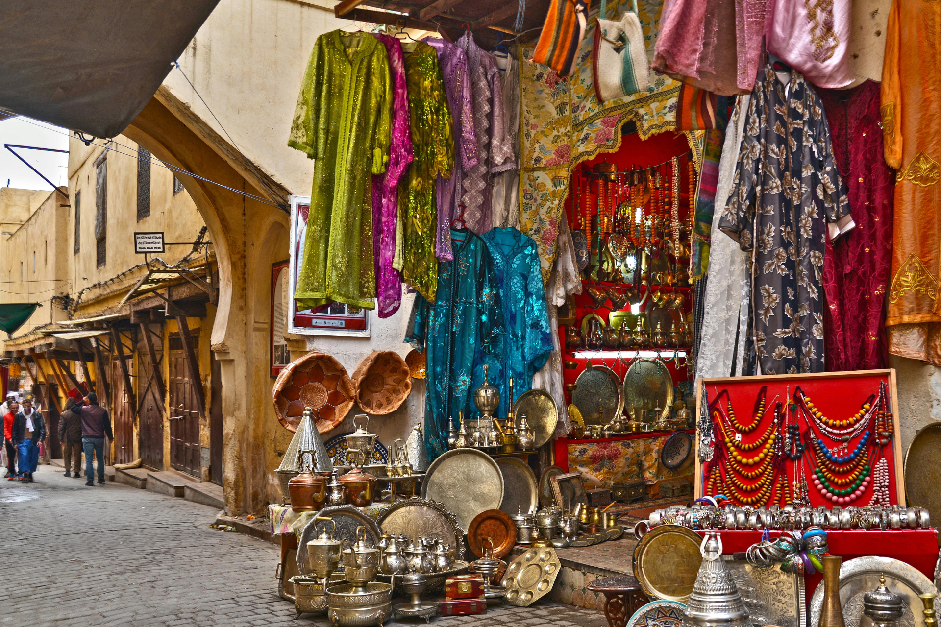 A market with a lot of clothes hanging on the walls