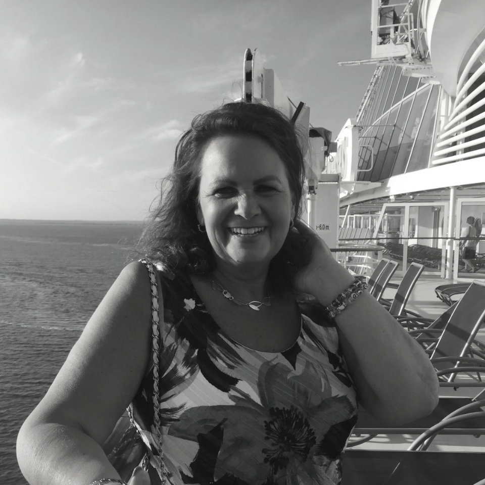 A black and white photo of a woman on a cruise ship