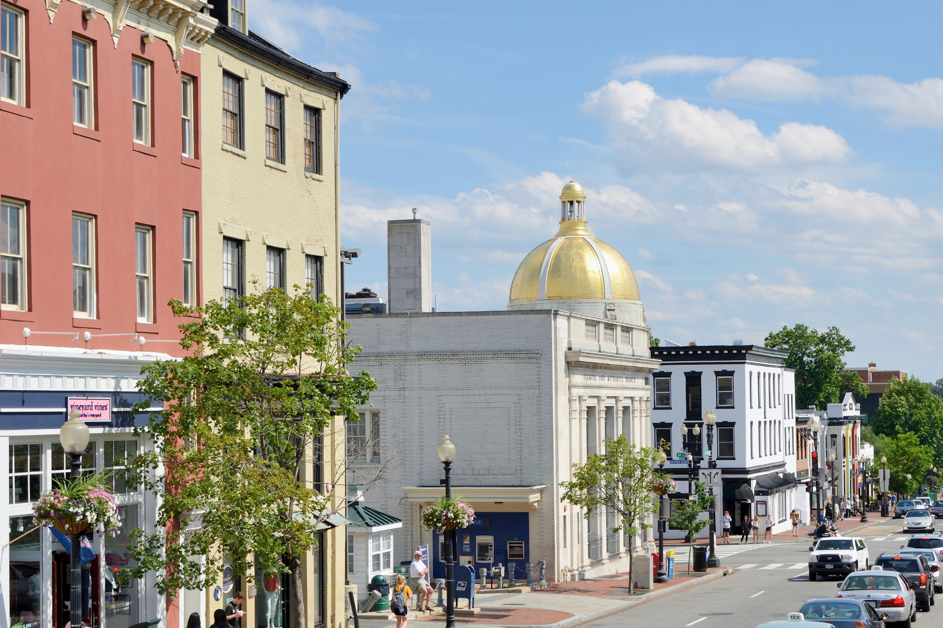 A city street with a dome on top of a building