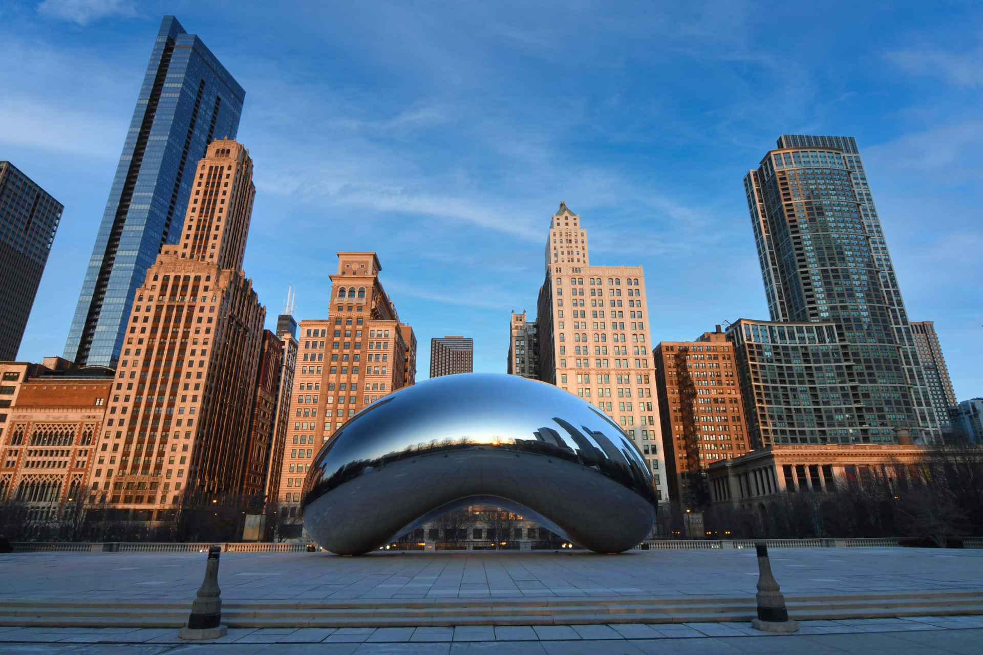 A cityscape with a bean sculpture in the foreground