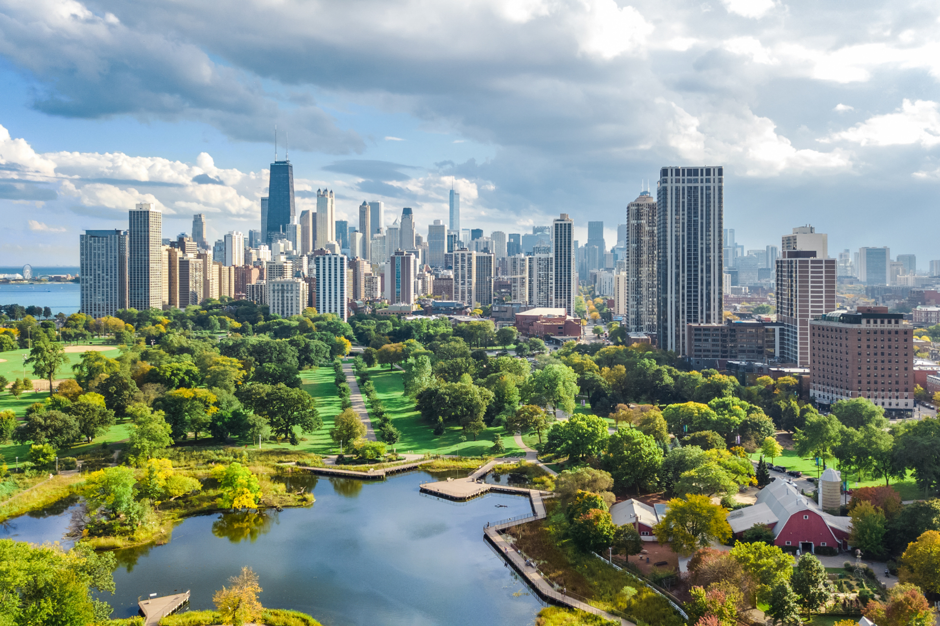 An aerial view of a city skyline with a park in the foreground.