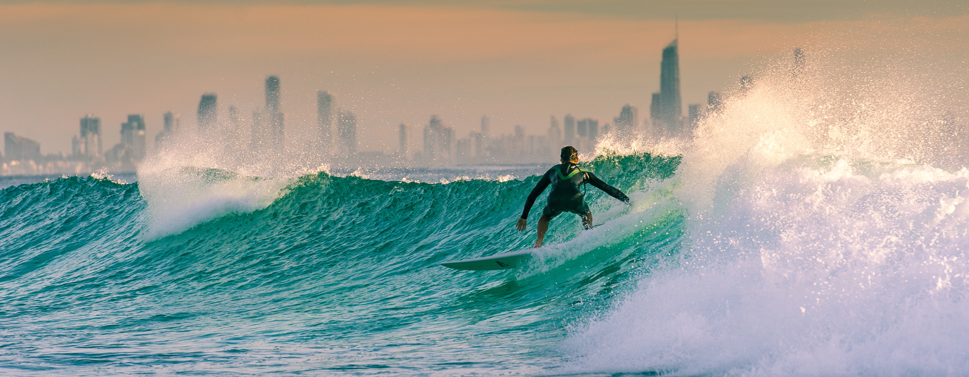 A man is riding a wave on a surfboard in the ocean.