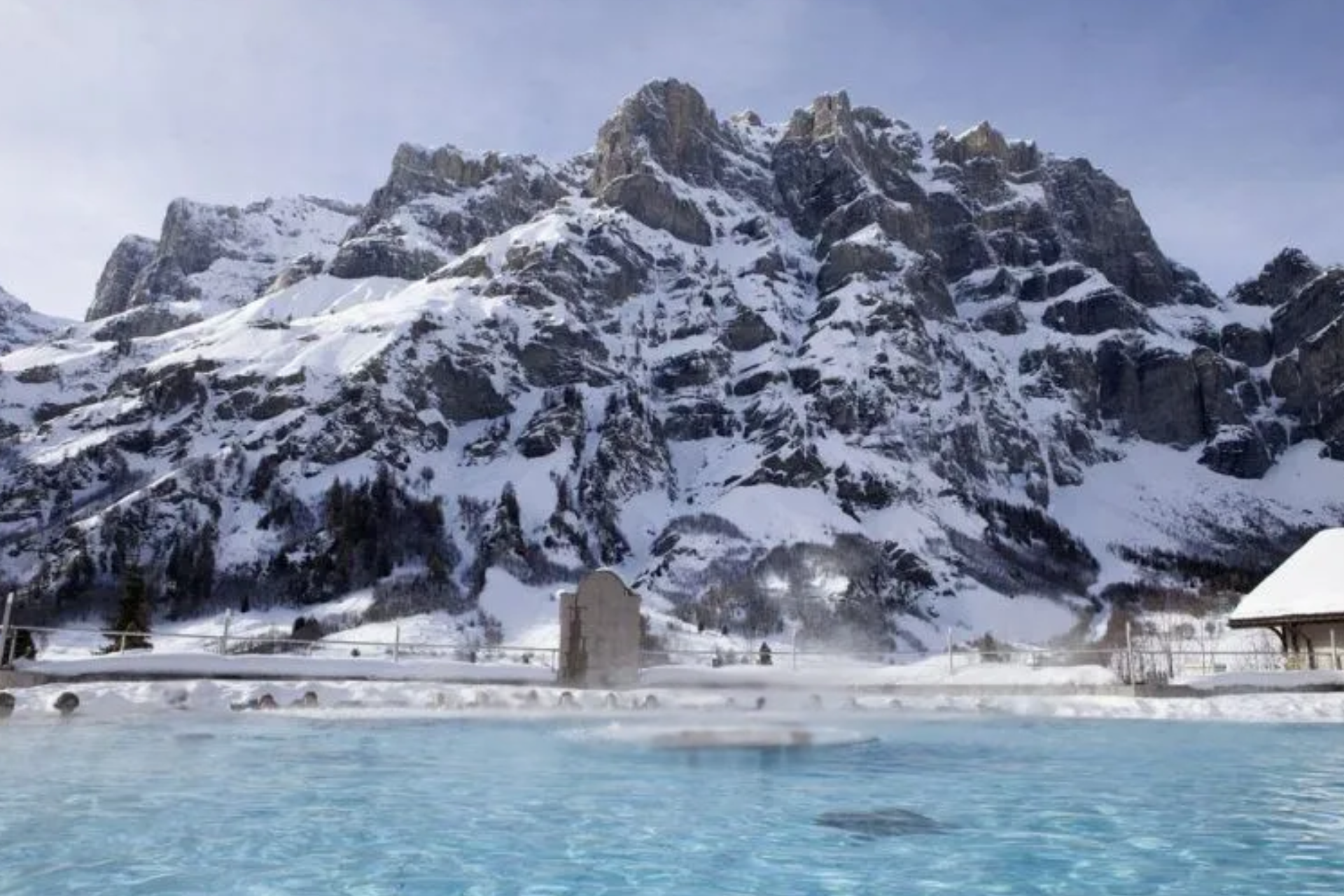 A swimming pool with a mountain in the background