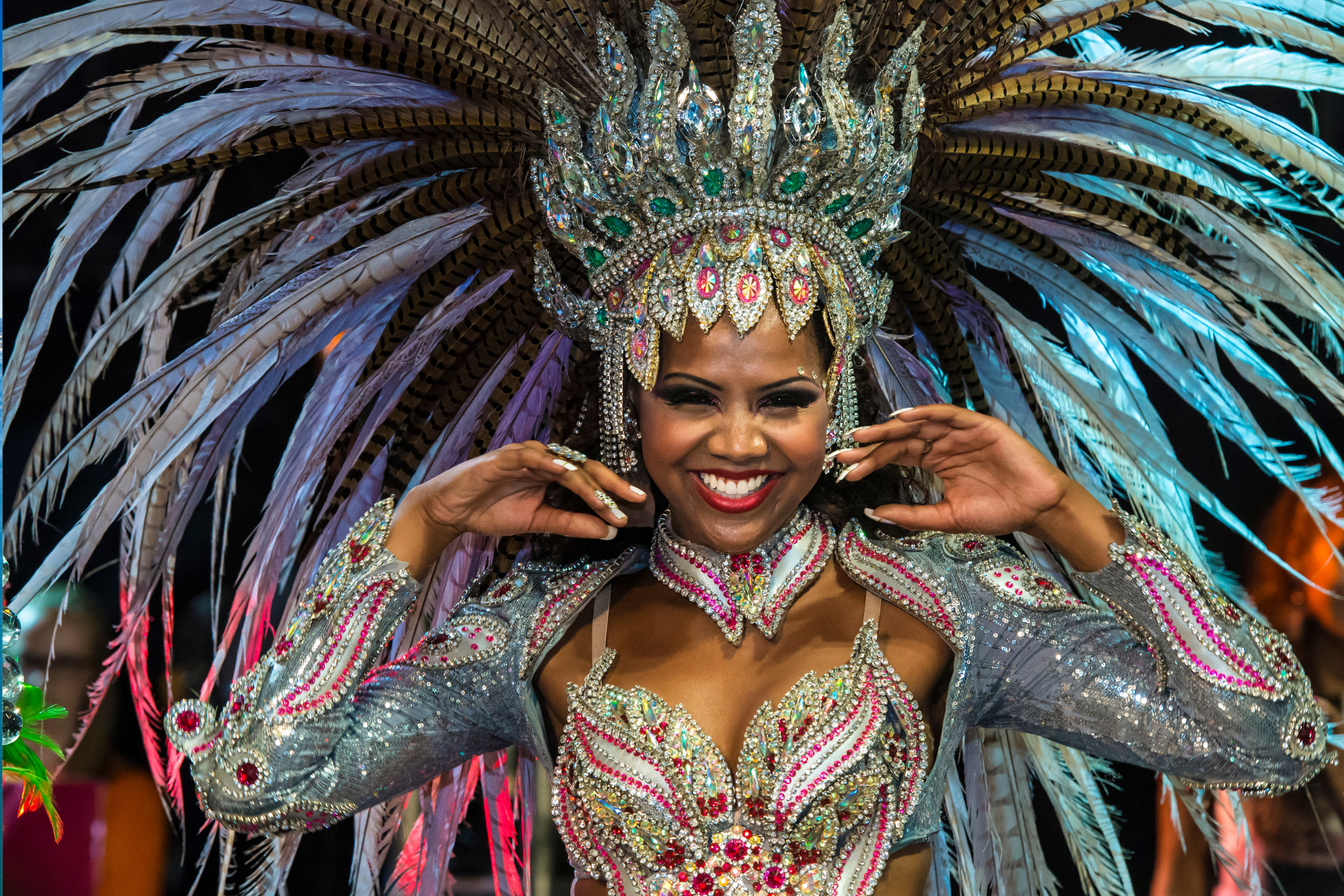 A woman in a colorful costume with feathers on her head