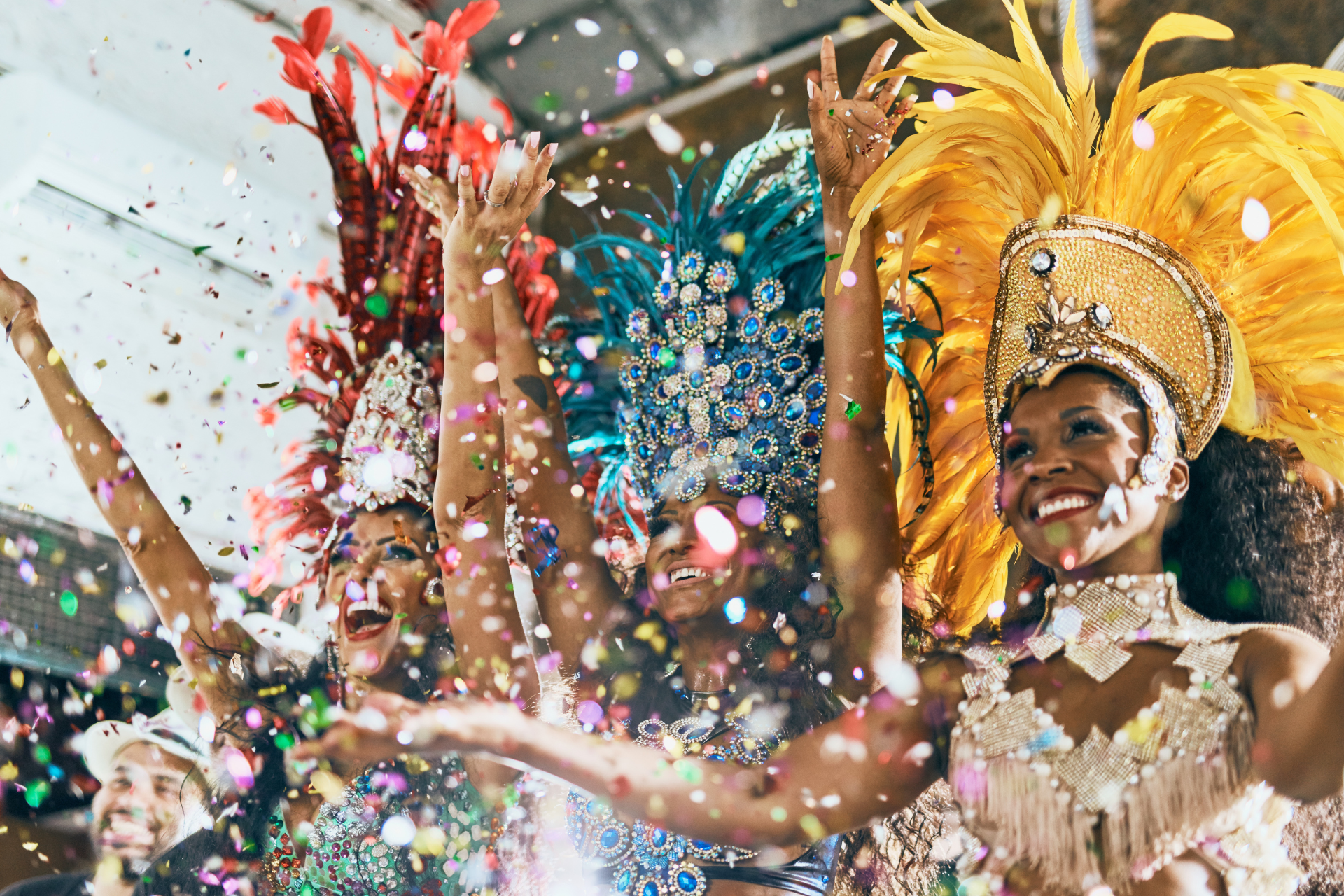 A group of women in colorful costumes are dancing at a carnival.