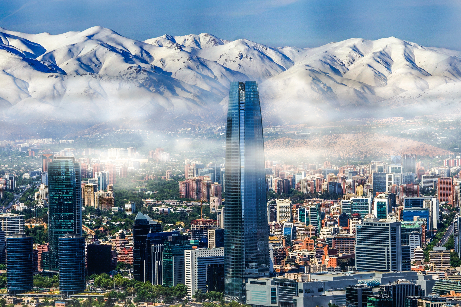 An aerial view of a city with mountains in the background.