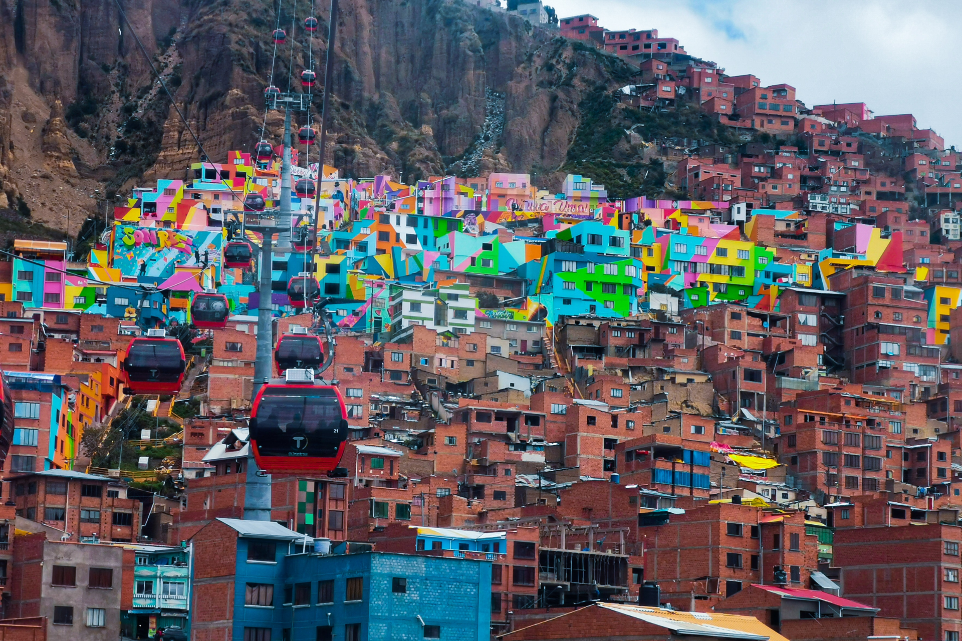 A colorful city with a cable car in the foreground