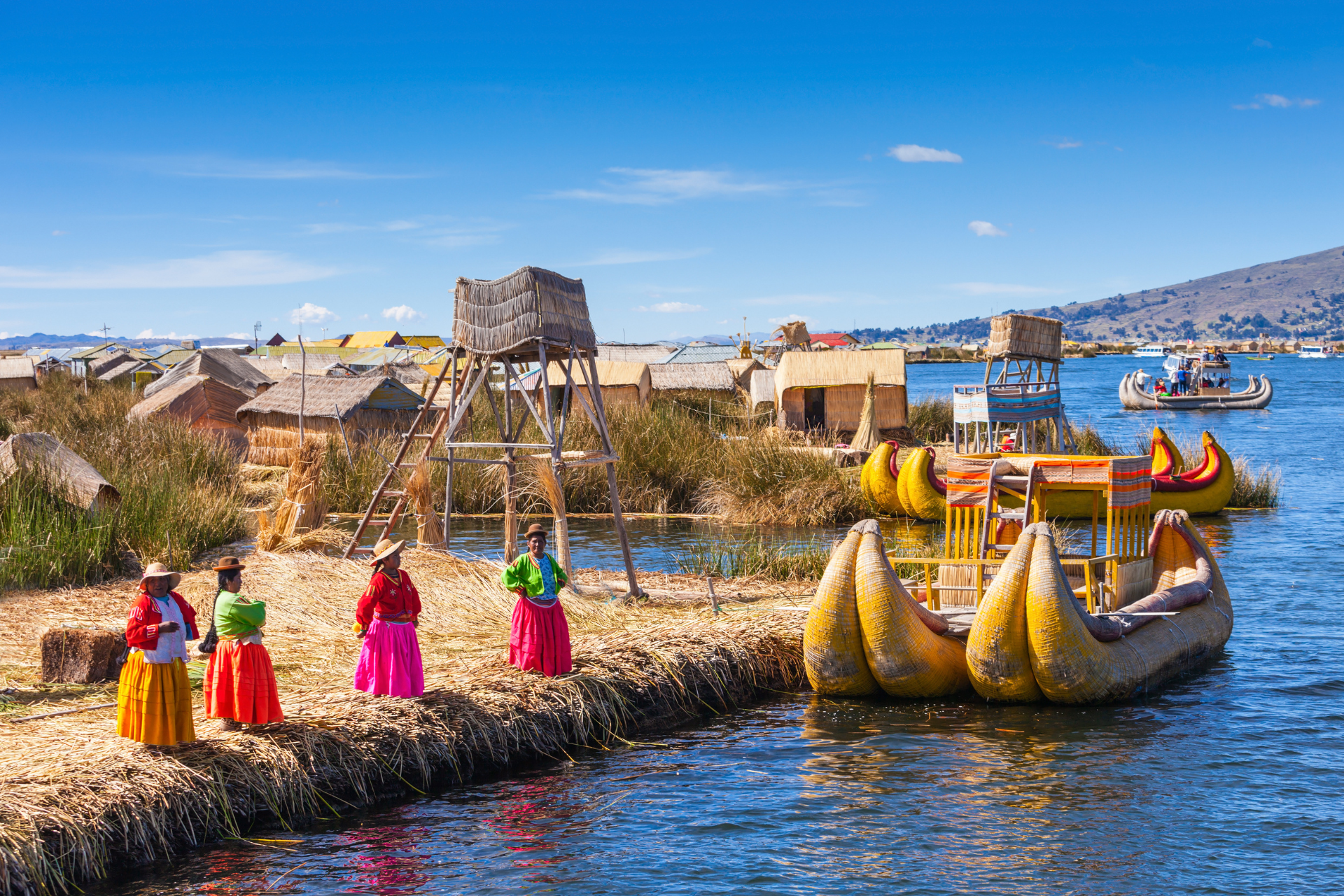 A group of women are standing on a small island in the middle of a lake.