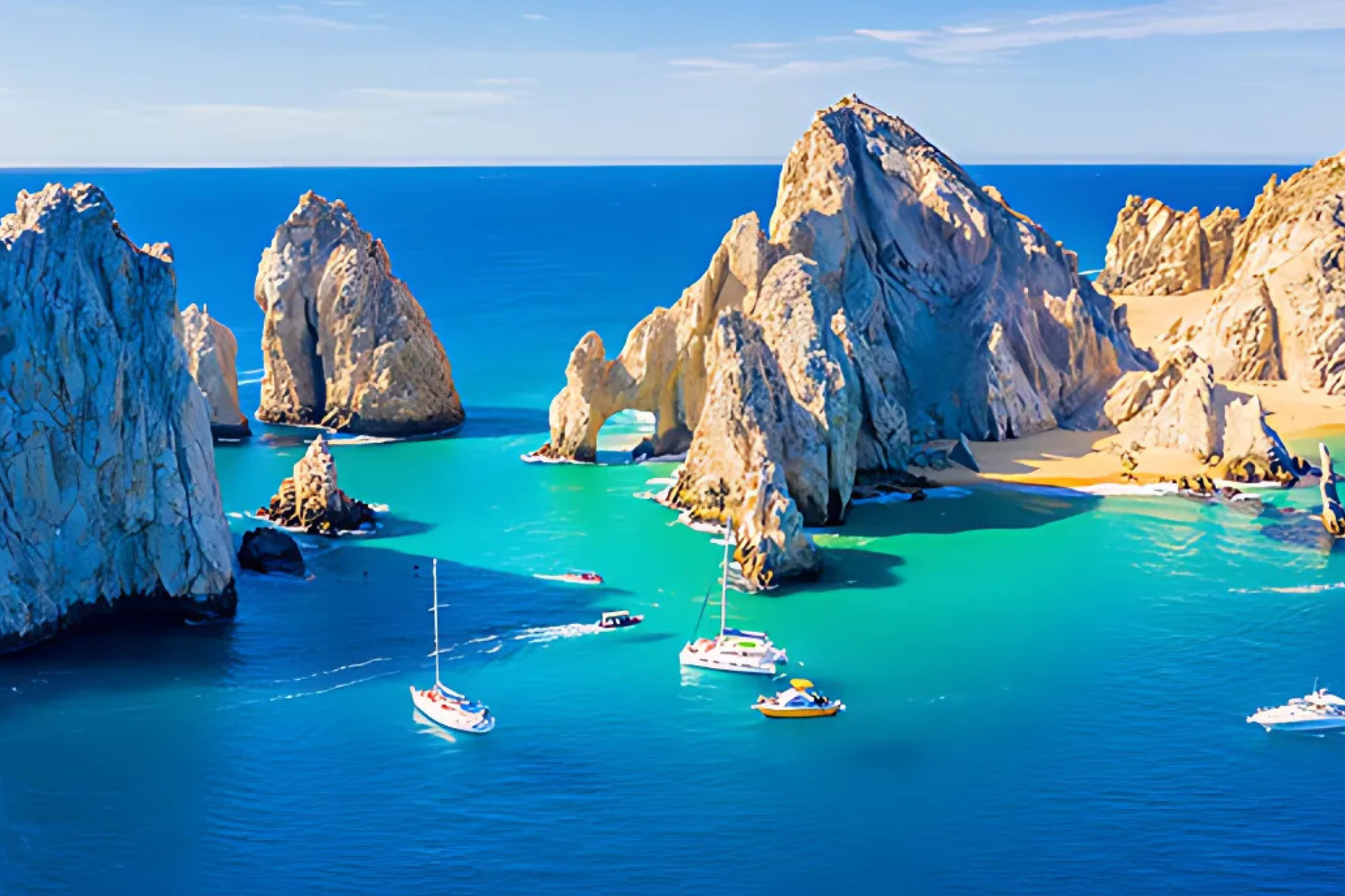 A group of boats are floating on top of a body of water surrounded by rocks.