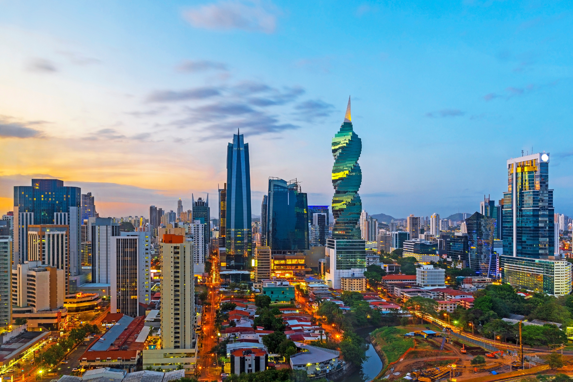 An aerial view of a city skyline at sunset.