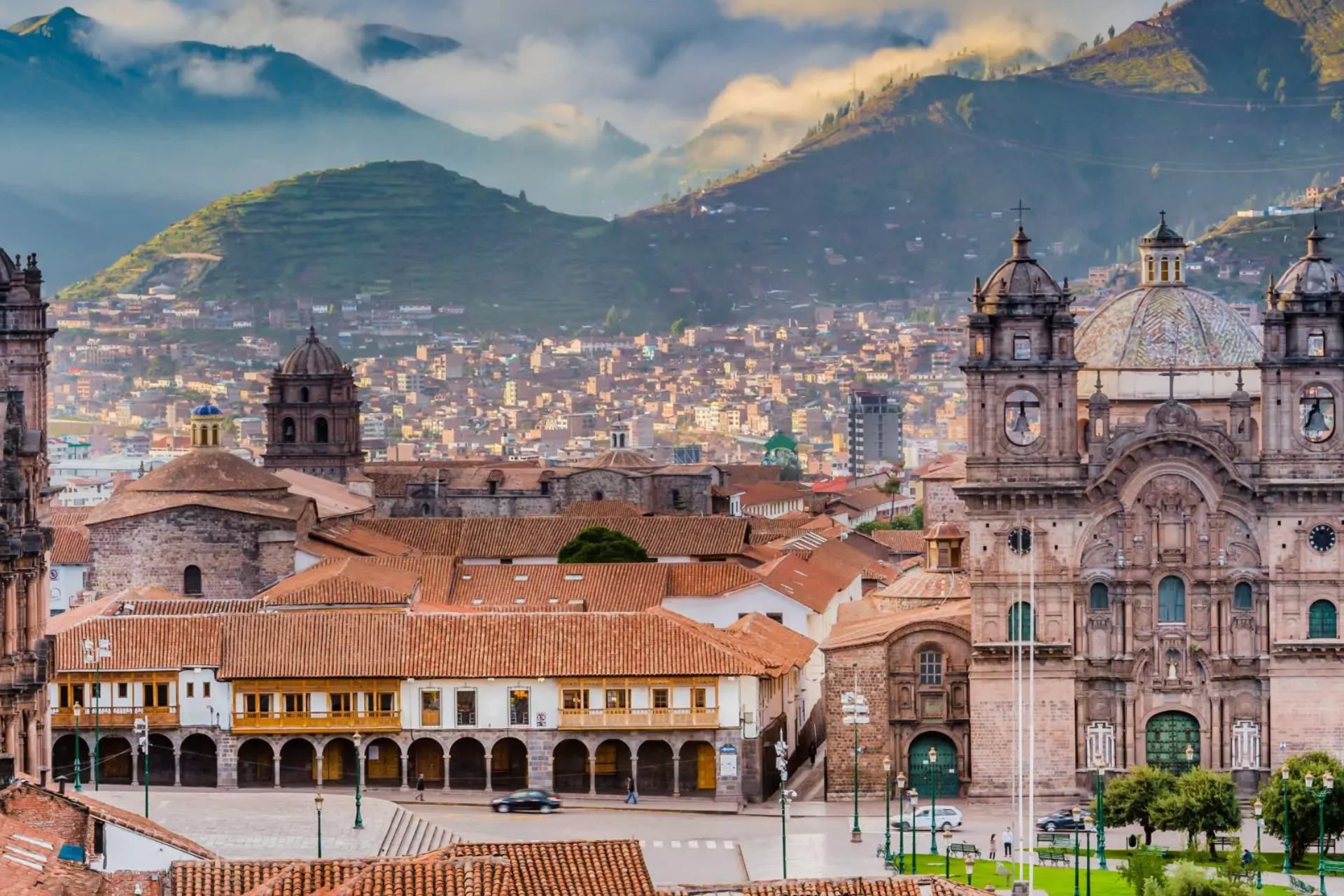 An aerial view of a city with mountains in the background.