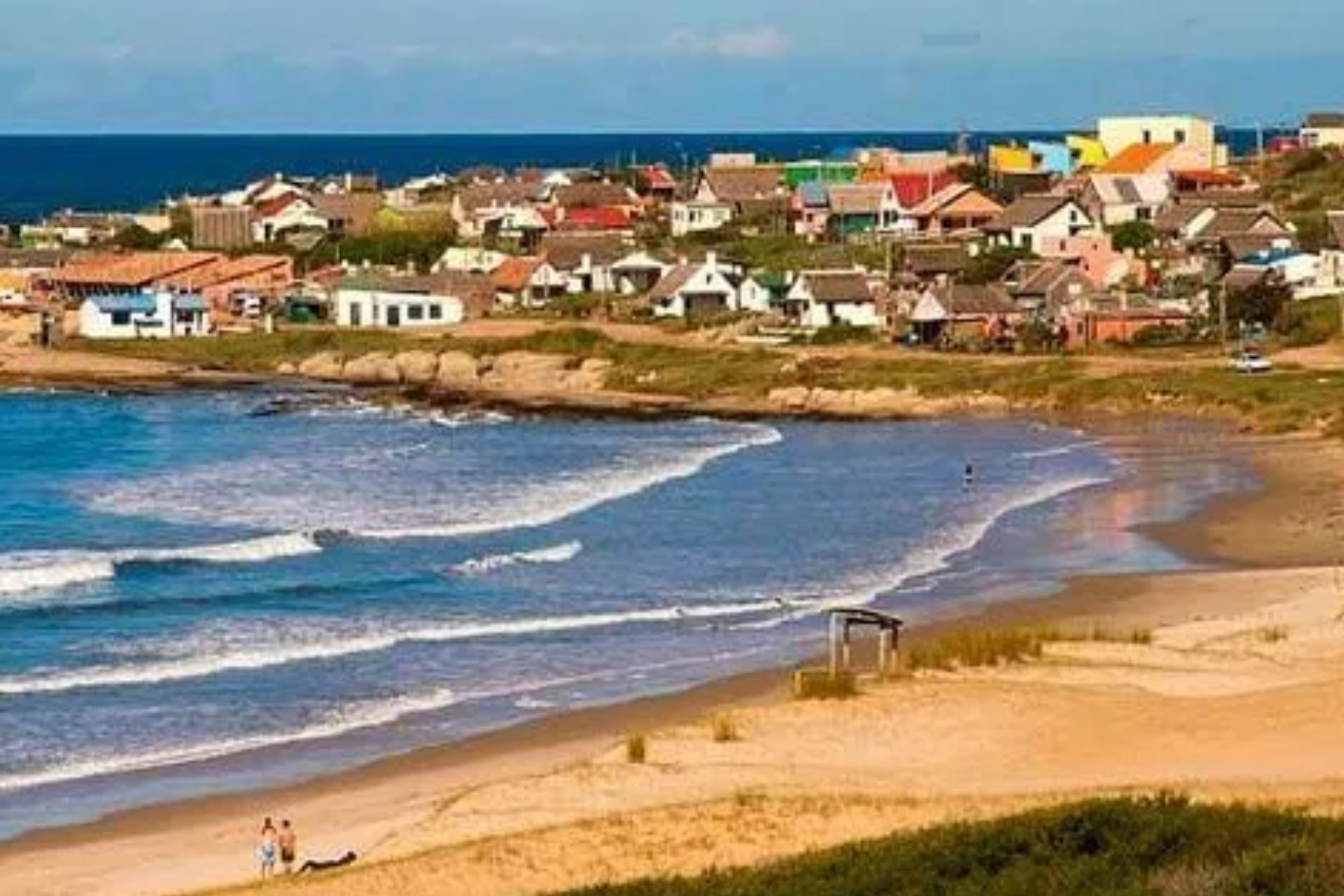 A beach with a small town in the background