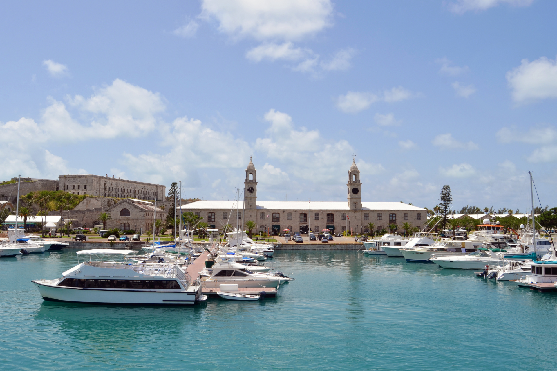 Boats are docked in a harbor with a building in the background