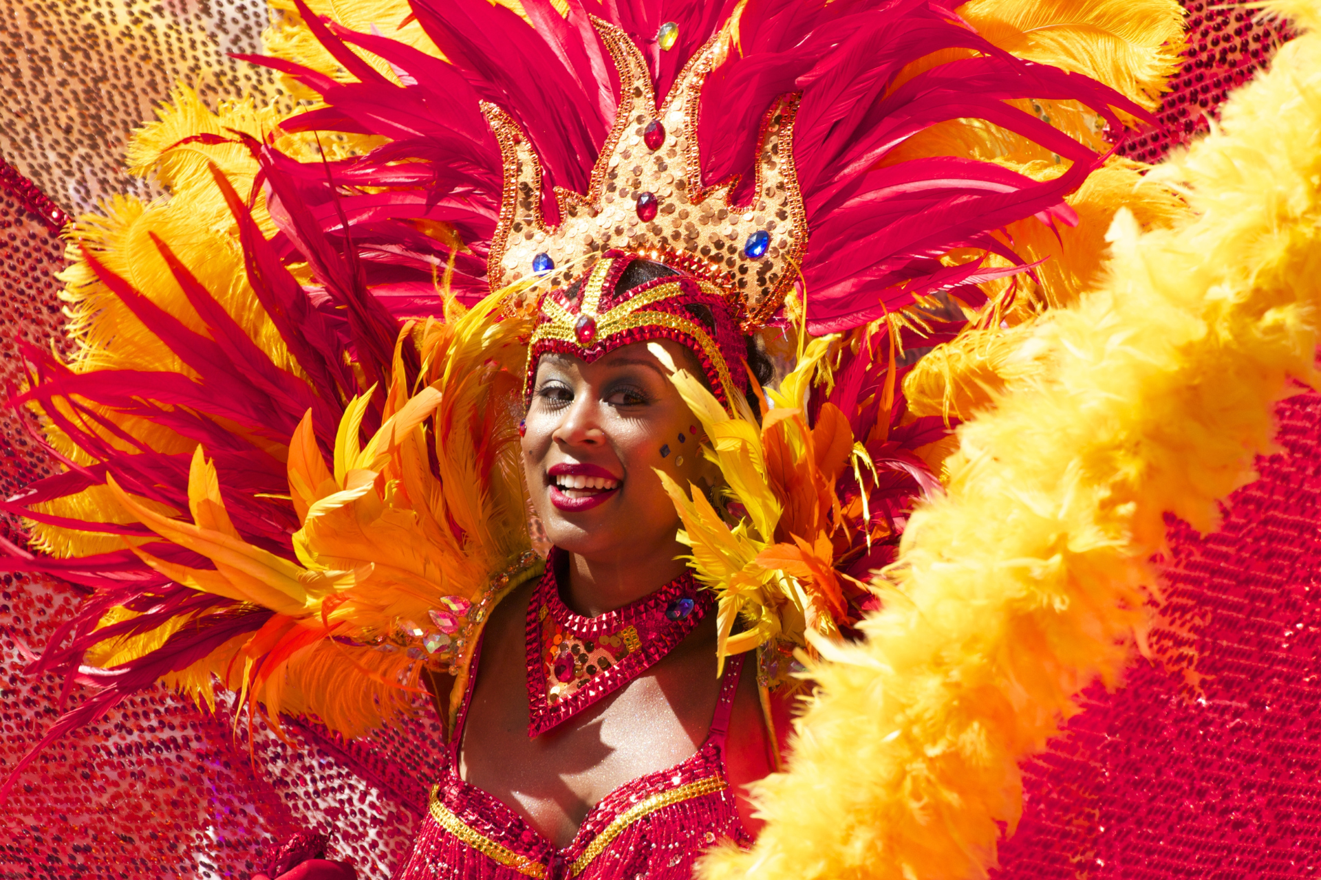 A woman is wearing a colorful costume at a carnival.