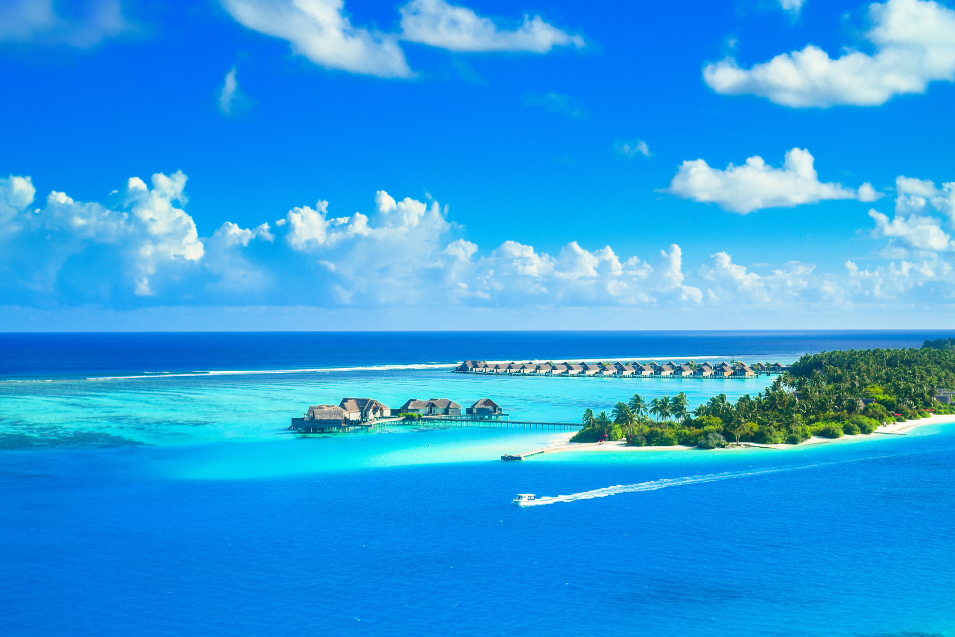 An aerial view of a tropical island in the middle of the ocean.