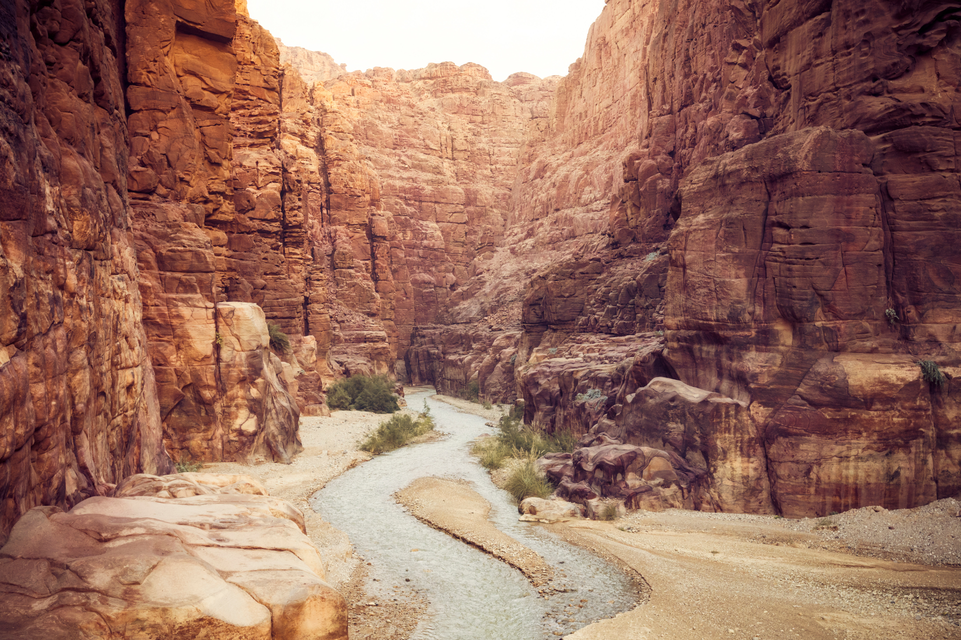 A river in the middle of a canyon surrounded by rocks.