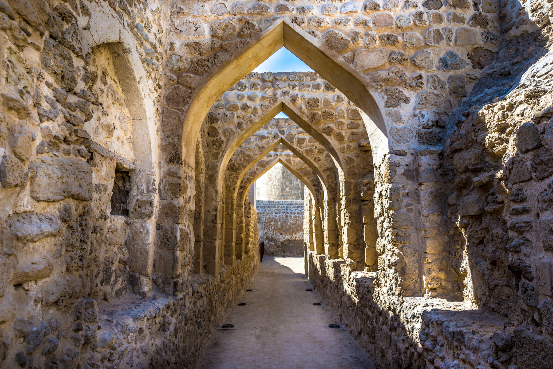 A stone tunnel with arches in the middle of it.