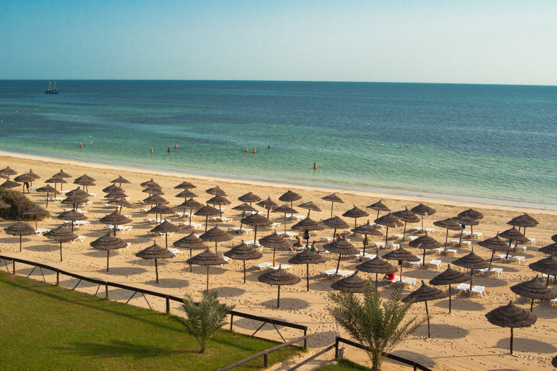 A beach filled with lots of umbrellas and chairs