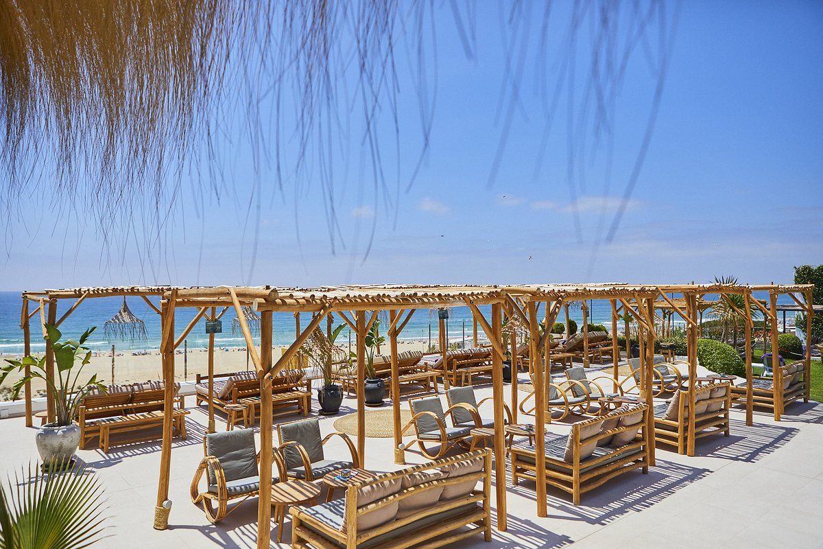 There are a lot of chairs and tables on the beach.