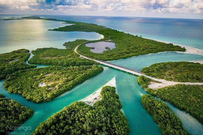 An aerial view of a bridge over a body of water surrounded by islands.