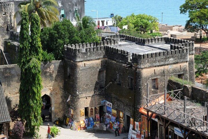 An aerial view of a castle with shops in front of it