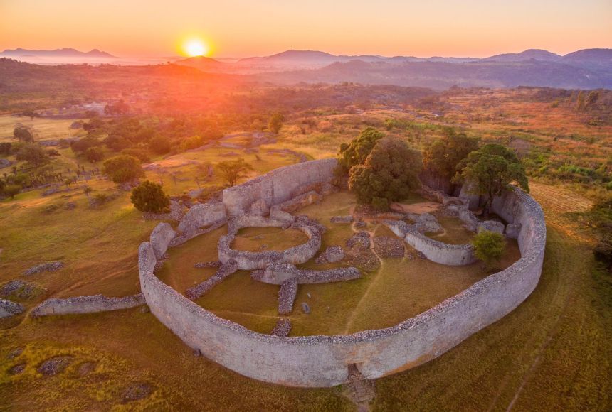 An aerial view of a large stone wall at sunset.