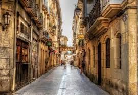 A narrow alleyway between two buildings in a city.