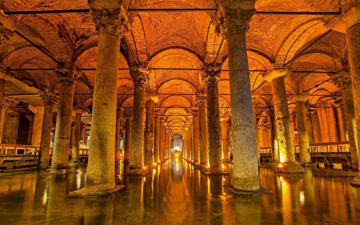 A large building with columns and arches filled with water.