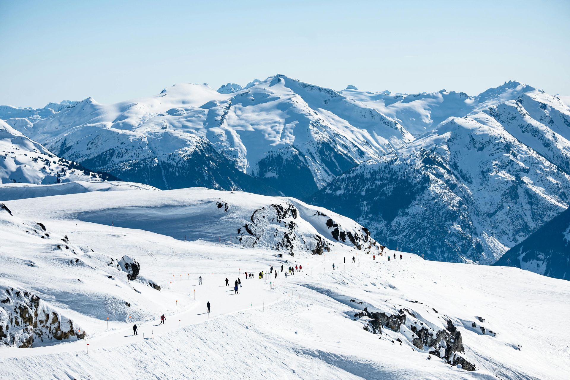 A group of people are skiing down a snow covered mountain.