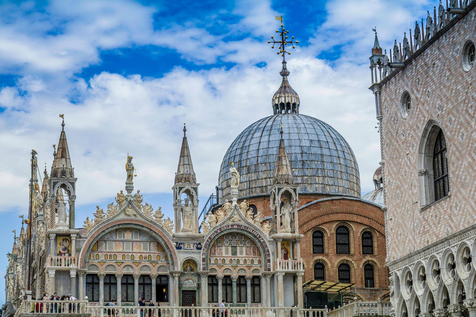 A large church with a dome and a cross on top of it.