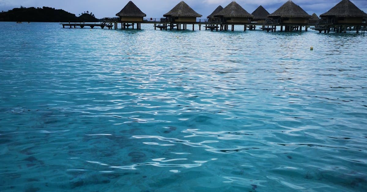 A row of bungalows on stilts in the middle of the ocean