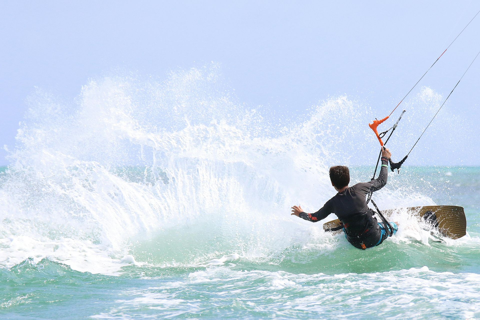 A man is riding a wave on a surfboard in the ocean.