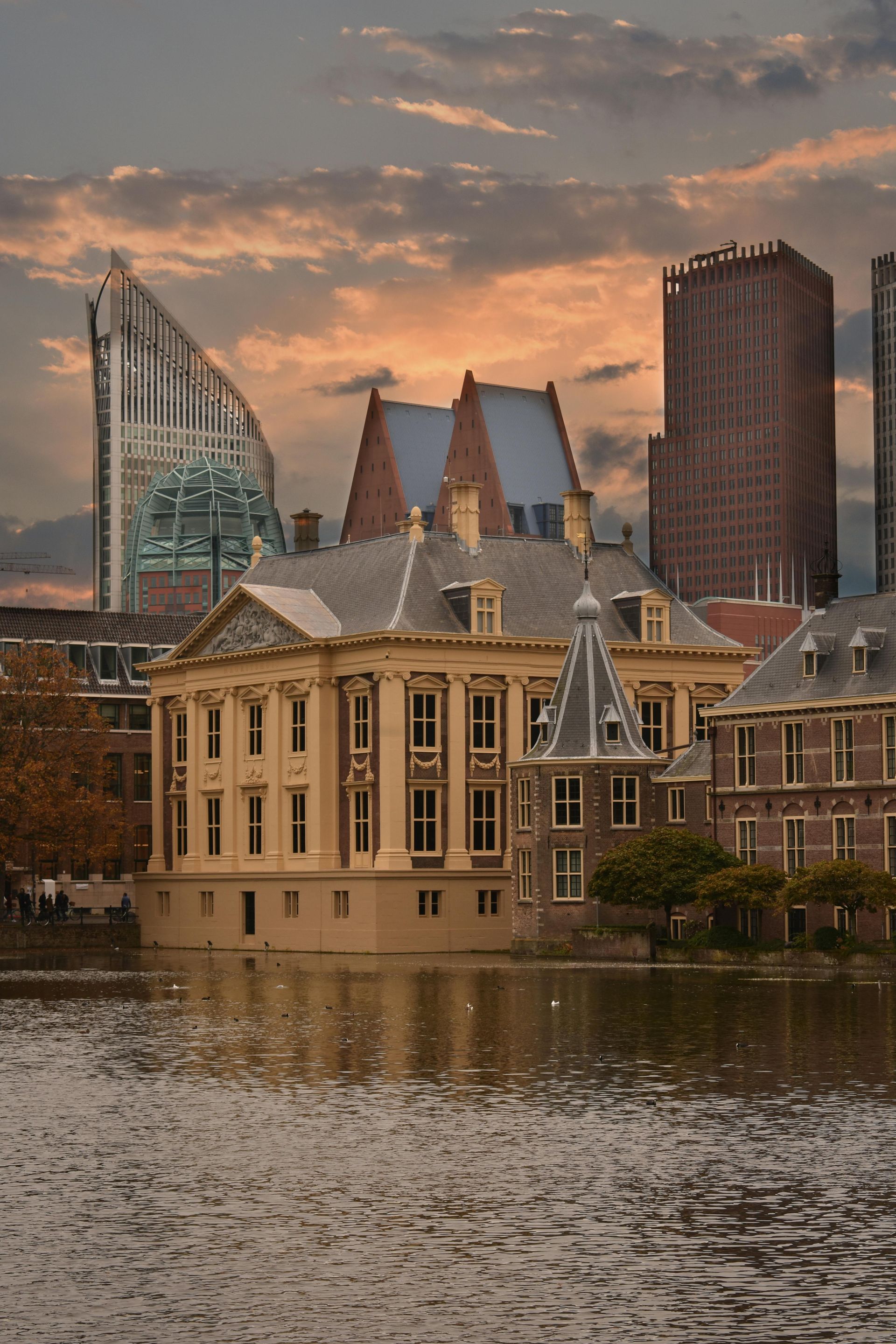 A large building is sitting in the middle of a body of water.