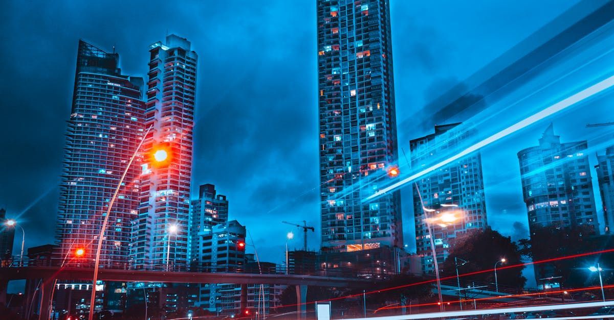 A city at night with a lot of tall buildings and a bridge.