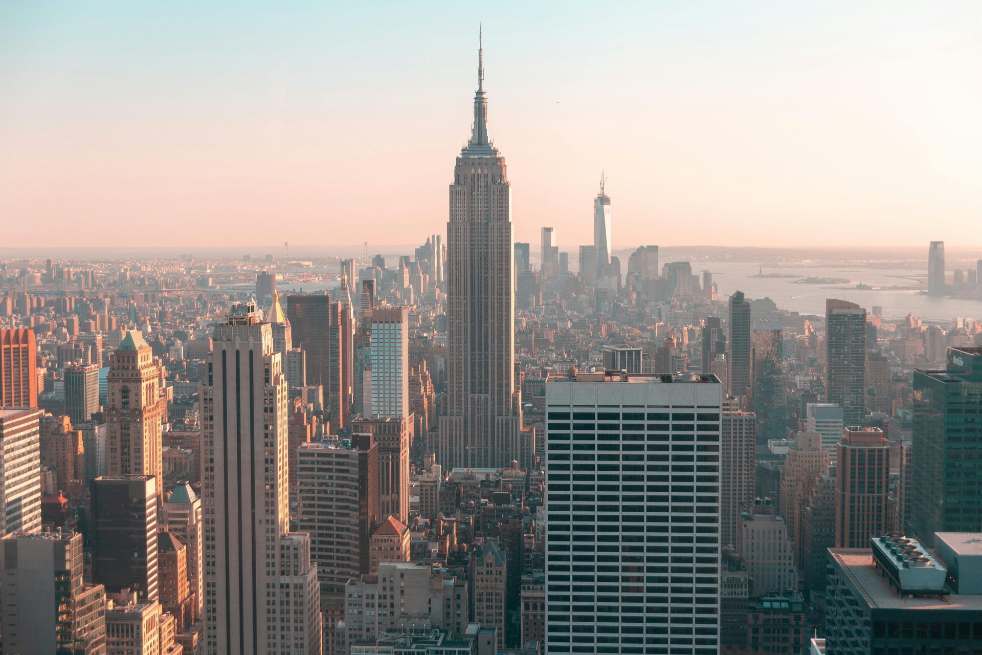 An aerial view of a city skyline with the empire state building in the foreground.