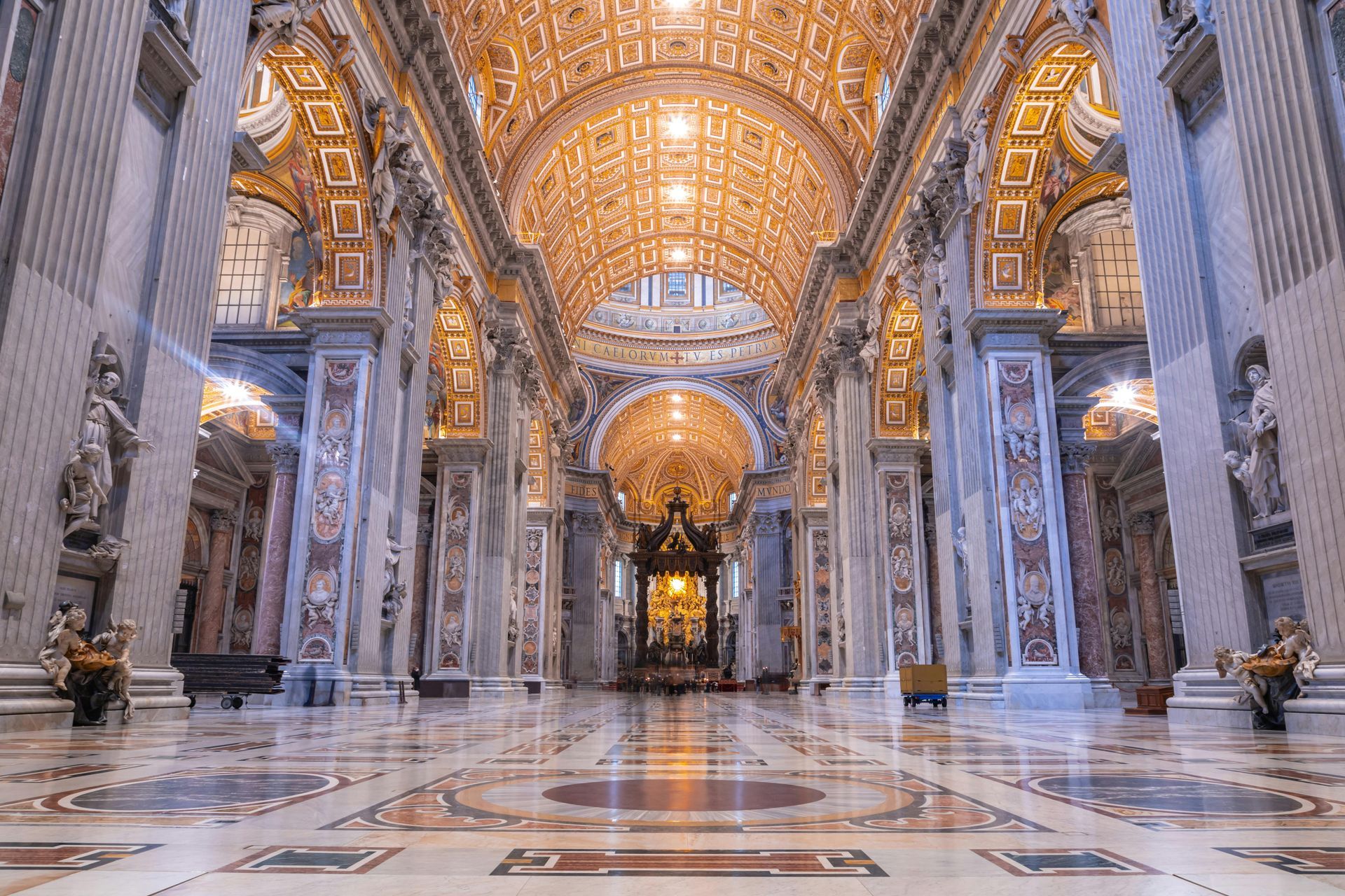 The inside of a large church with columns and a dome.