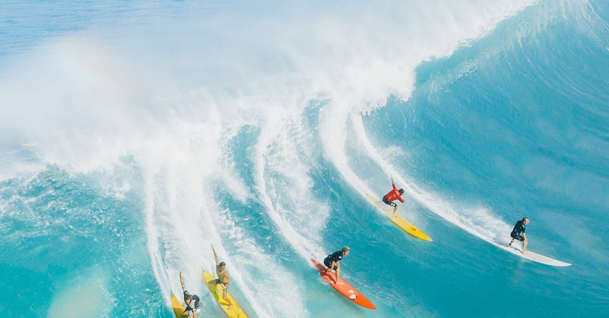 A group of surfers are riding a wave in the ocean.