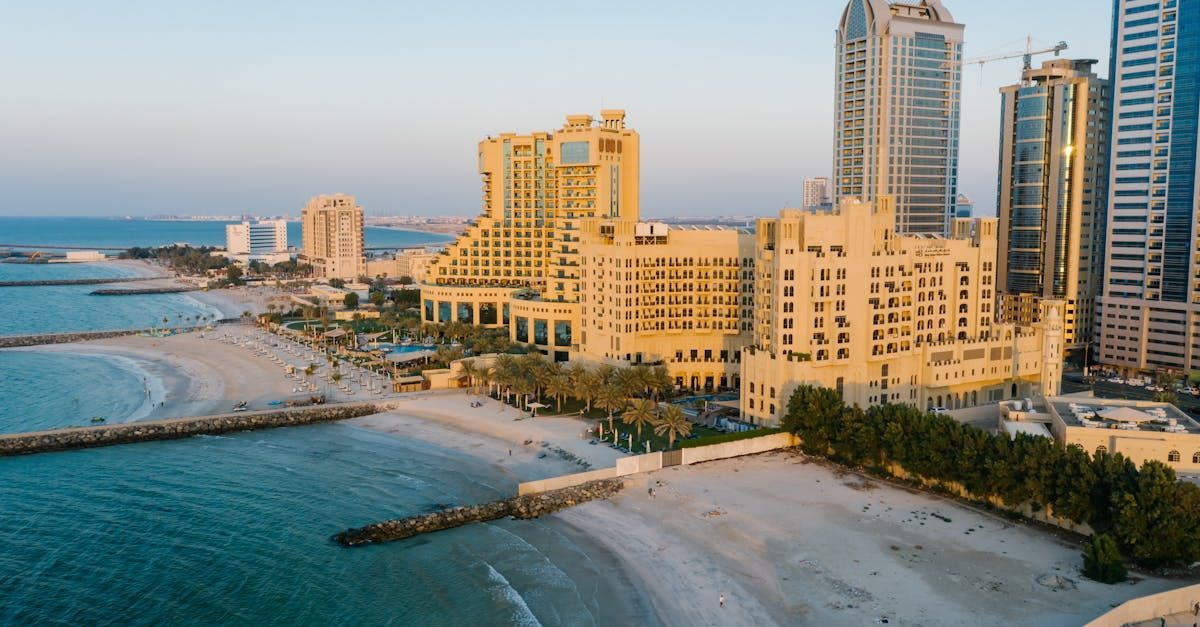 An aerial view of a city with a beach and buildings in the background.