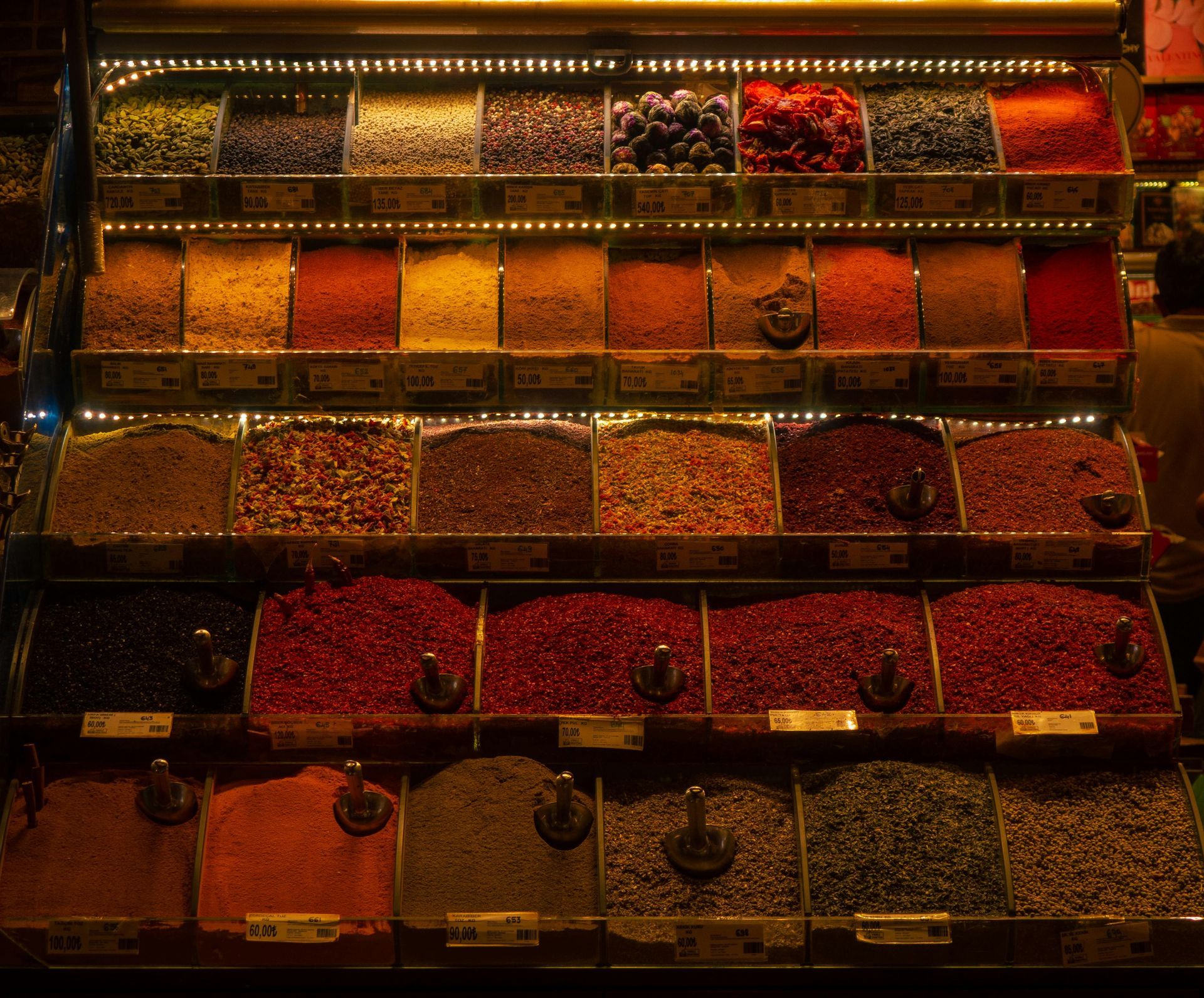 A variety of spices are displayed on a shelf in a store.