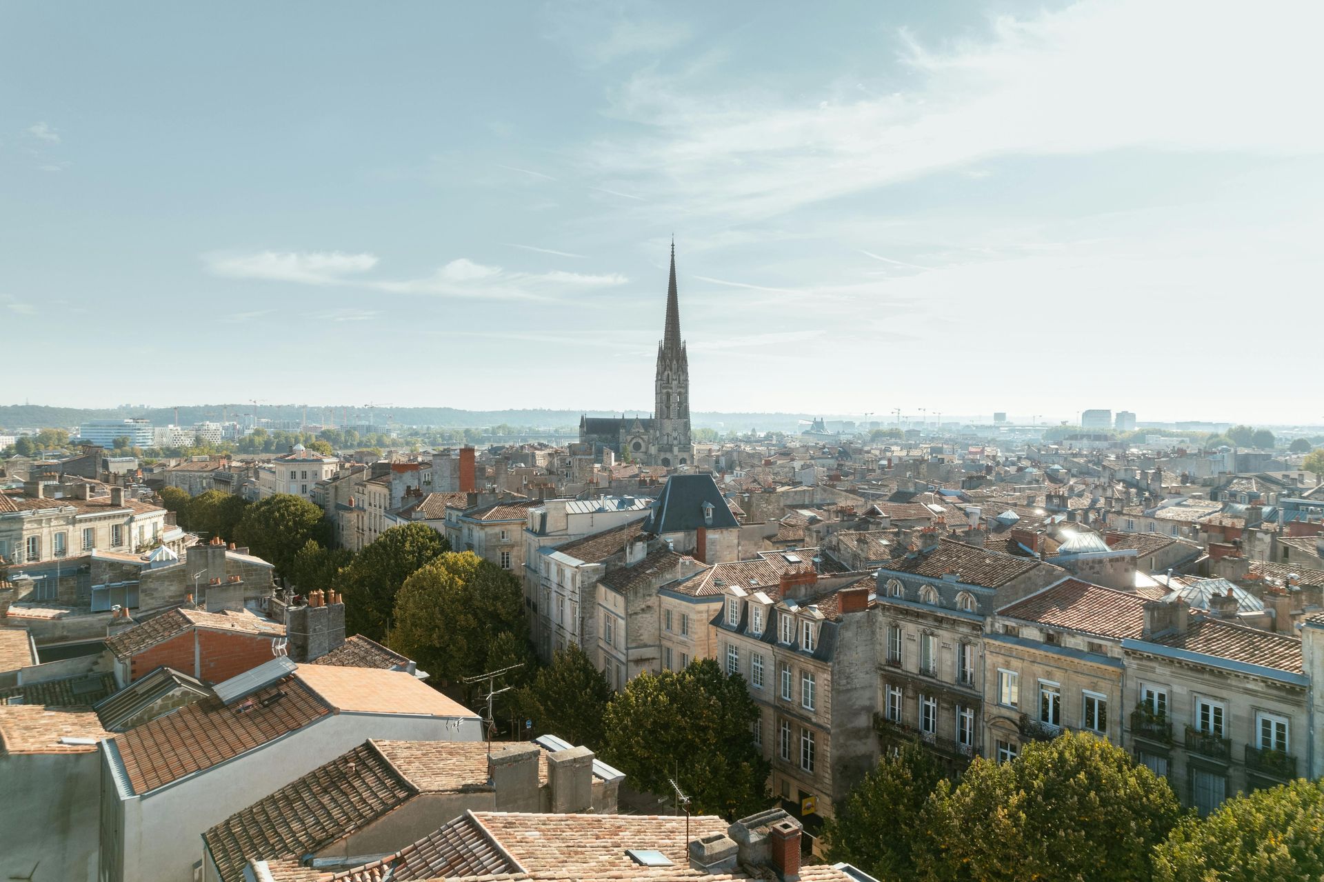 An aerial view of a city with a church in the background.