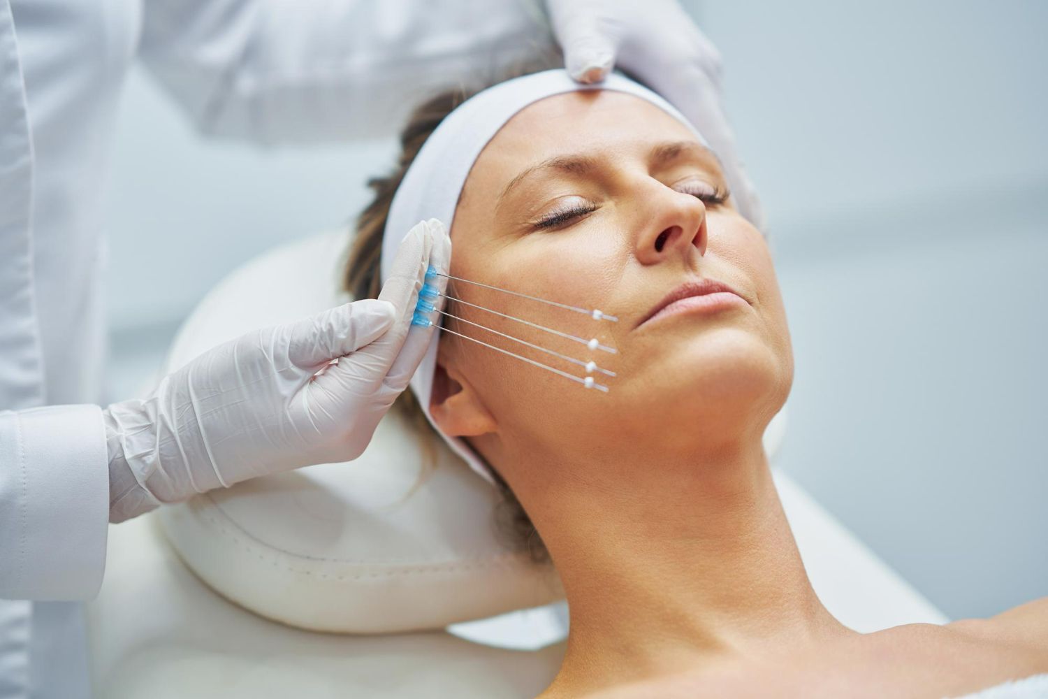 A woman is getting a botox injection in her face.