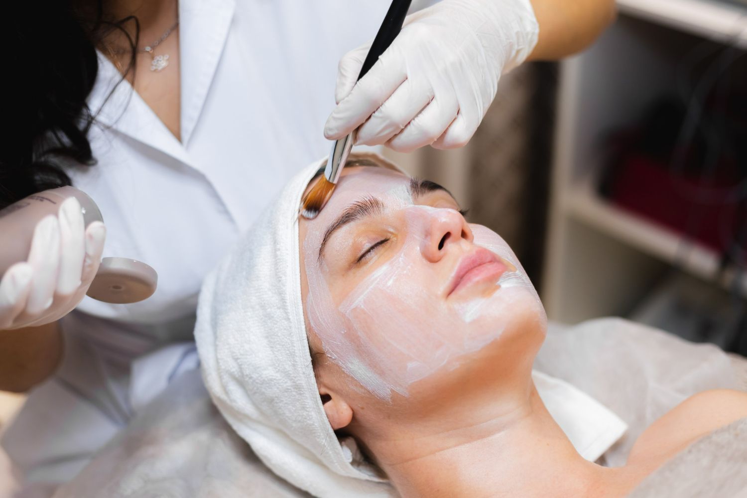 A woman is getting a facial treatment at a beauty salon.