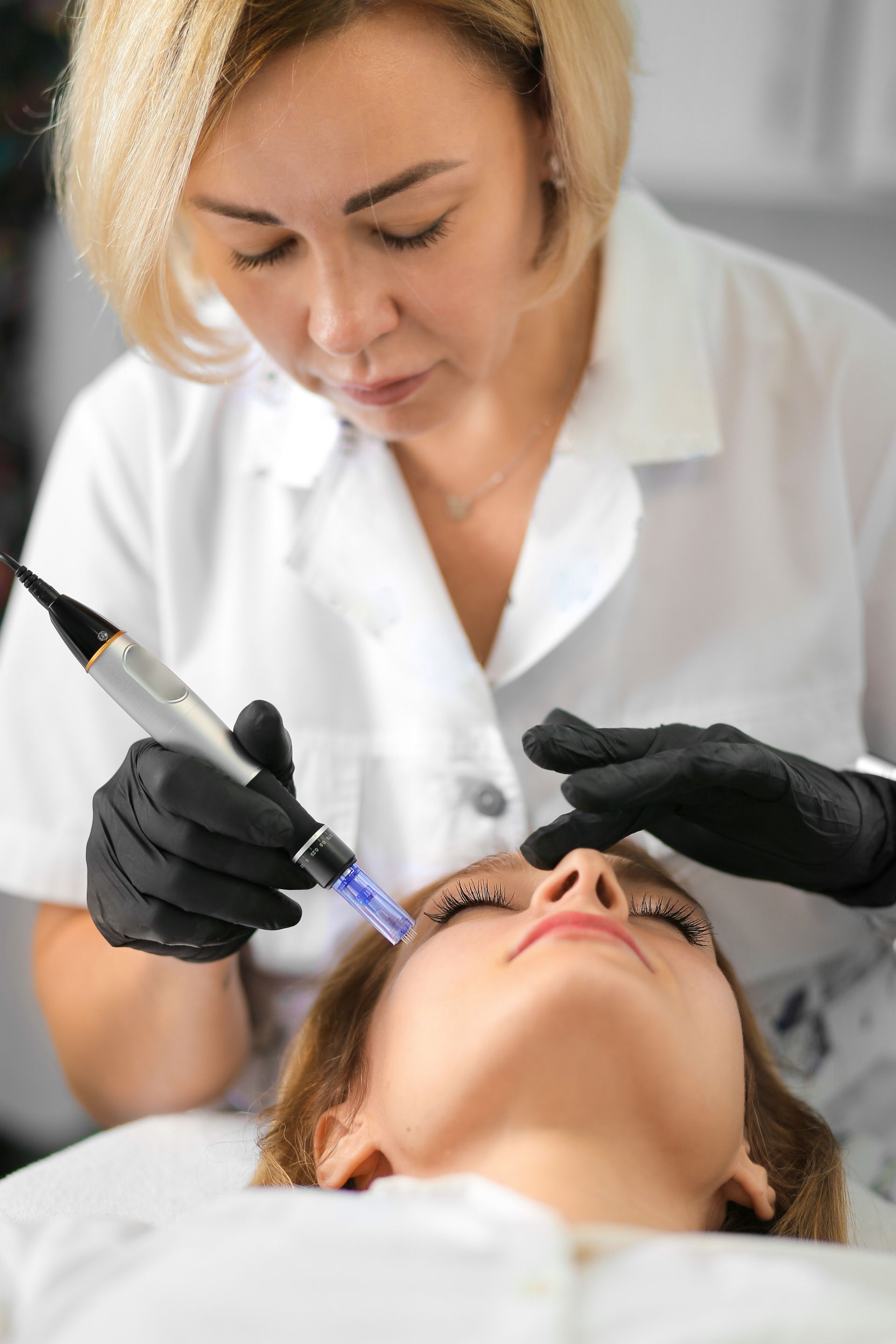 a woman is getting a facial treatment in a beauty salon .