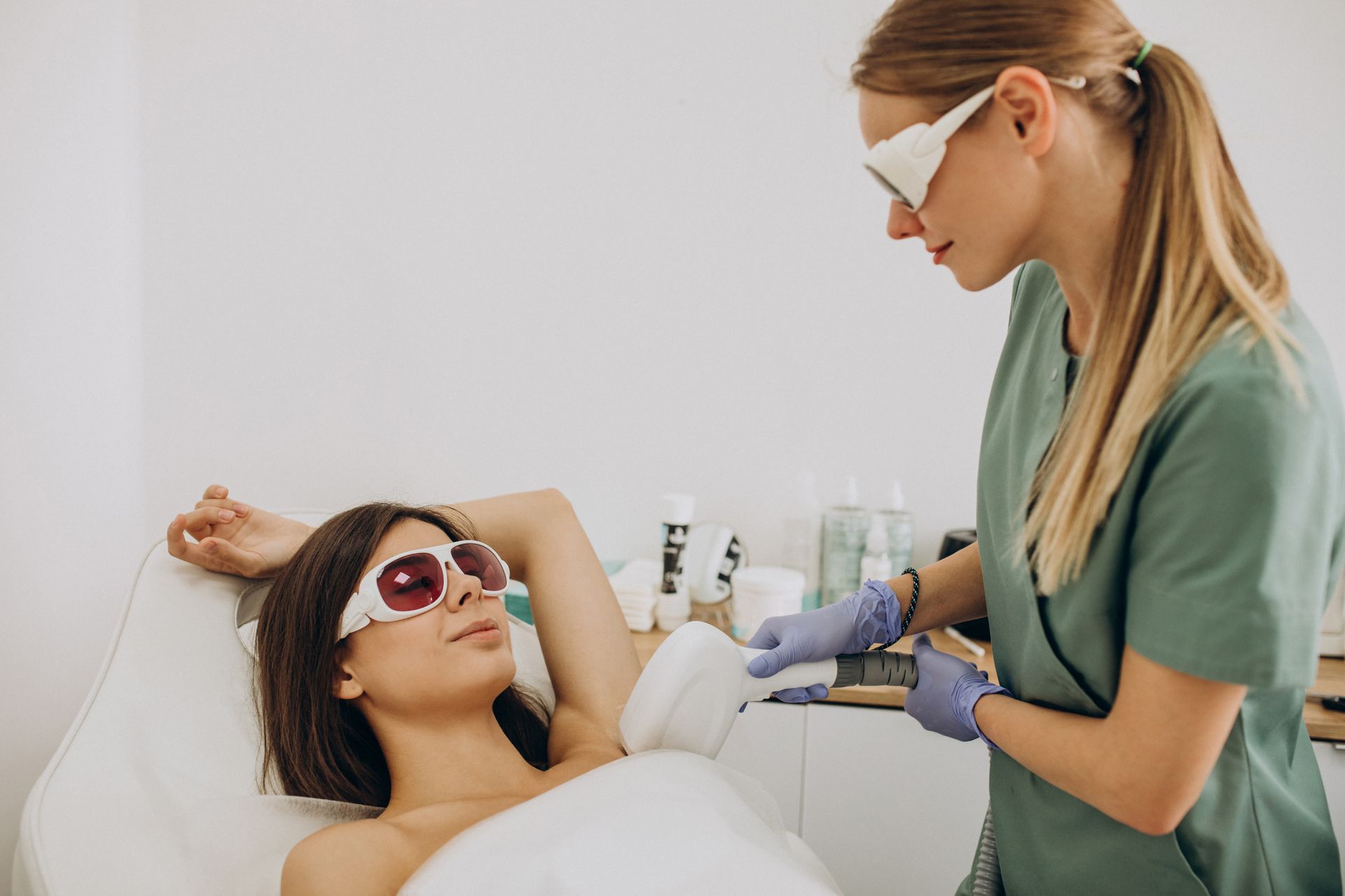 a woman is getting a laser hair removal treatment on her armpit .