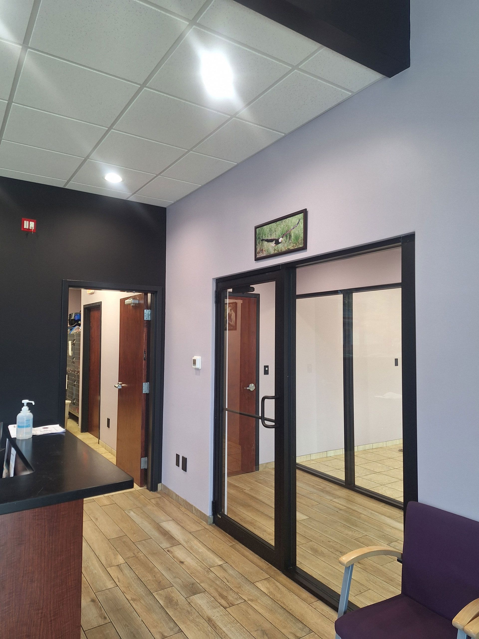 A waiting room with a purple chair and a table