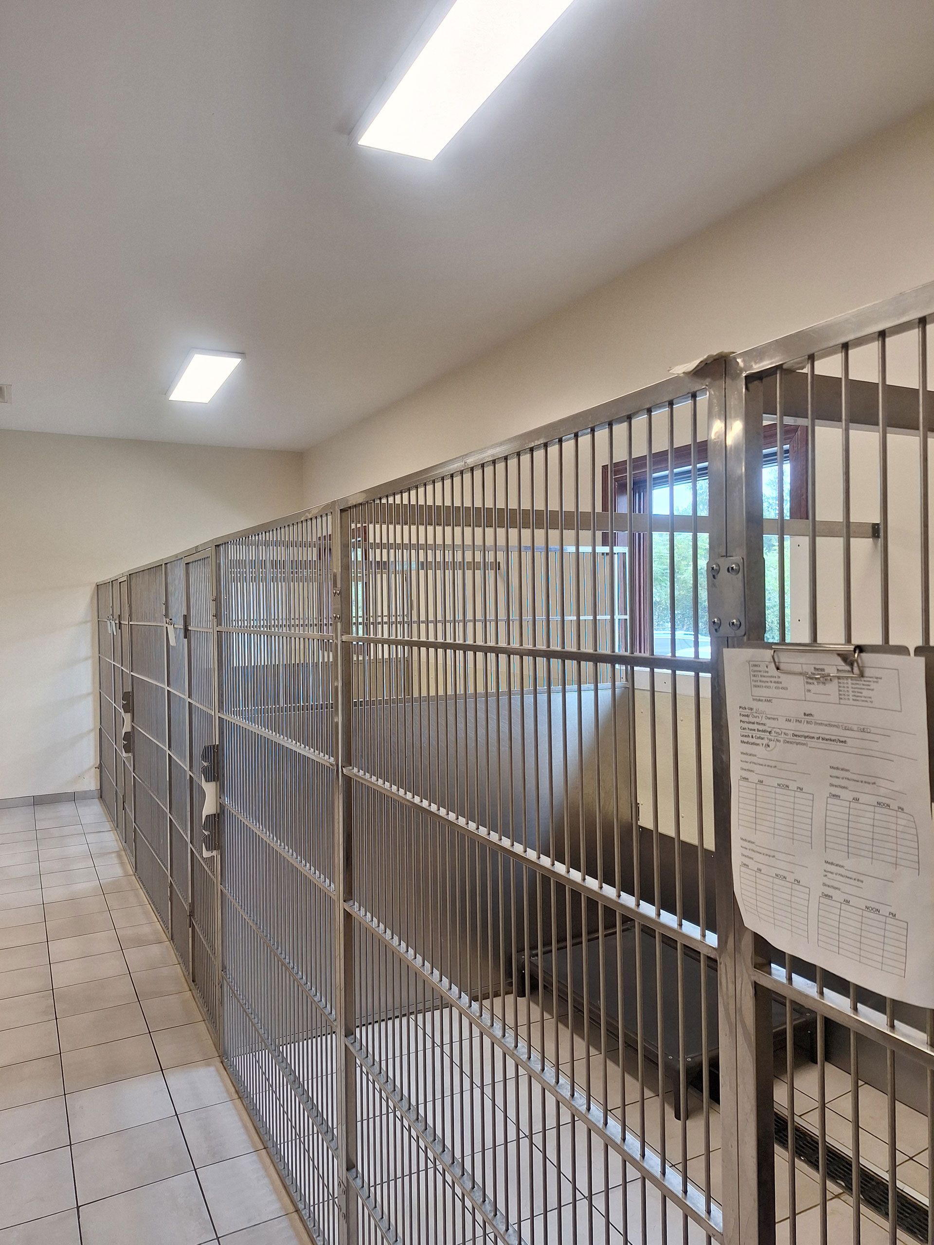 A row of stainless steel bars in a room with a window.