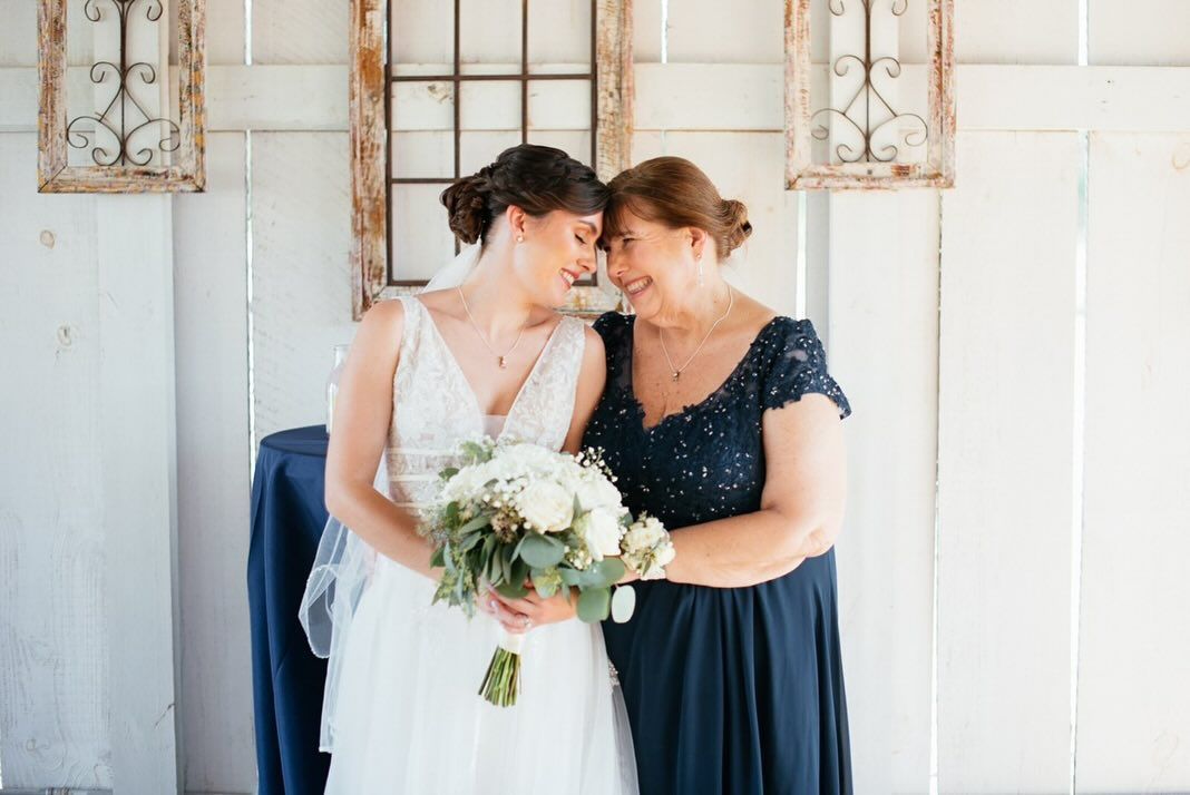 A woman is trying on a wedding dress in a bridal shop.