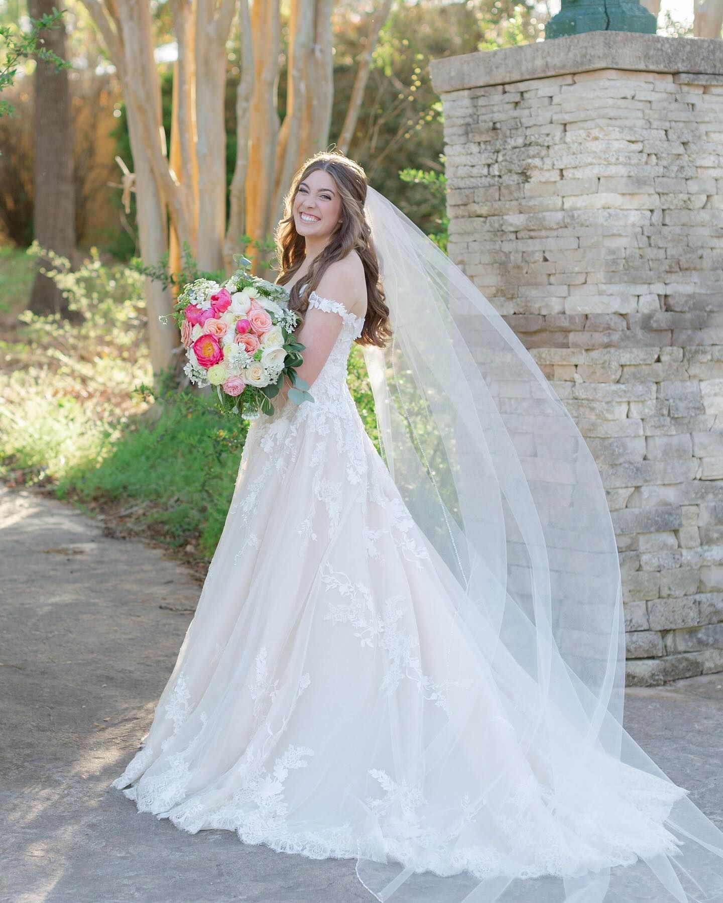 A woman is trying on a wedding dress in a bridal shop.