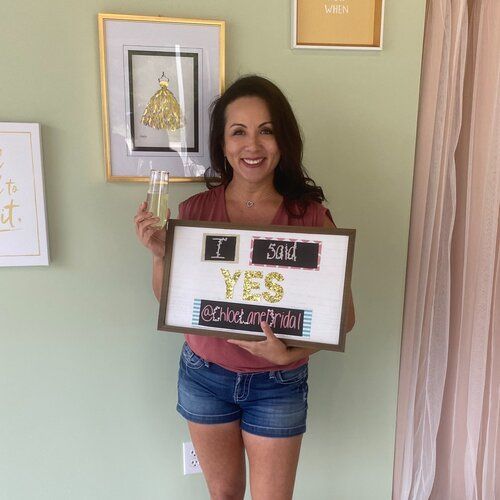 A woman is holding a sign that says i said yes